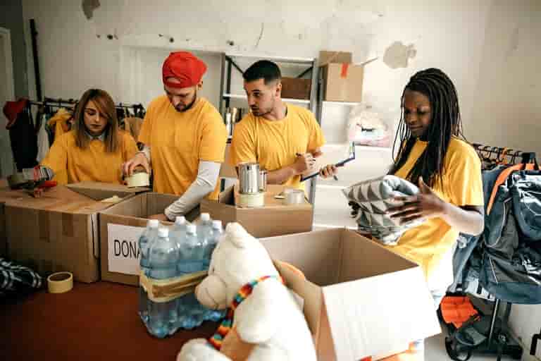 Volunteers packing donation boxes with supplies
