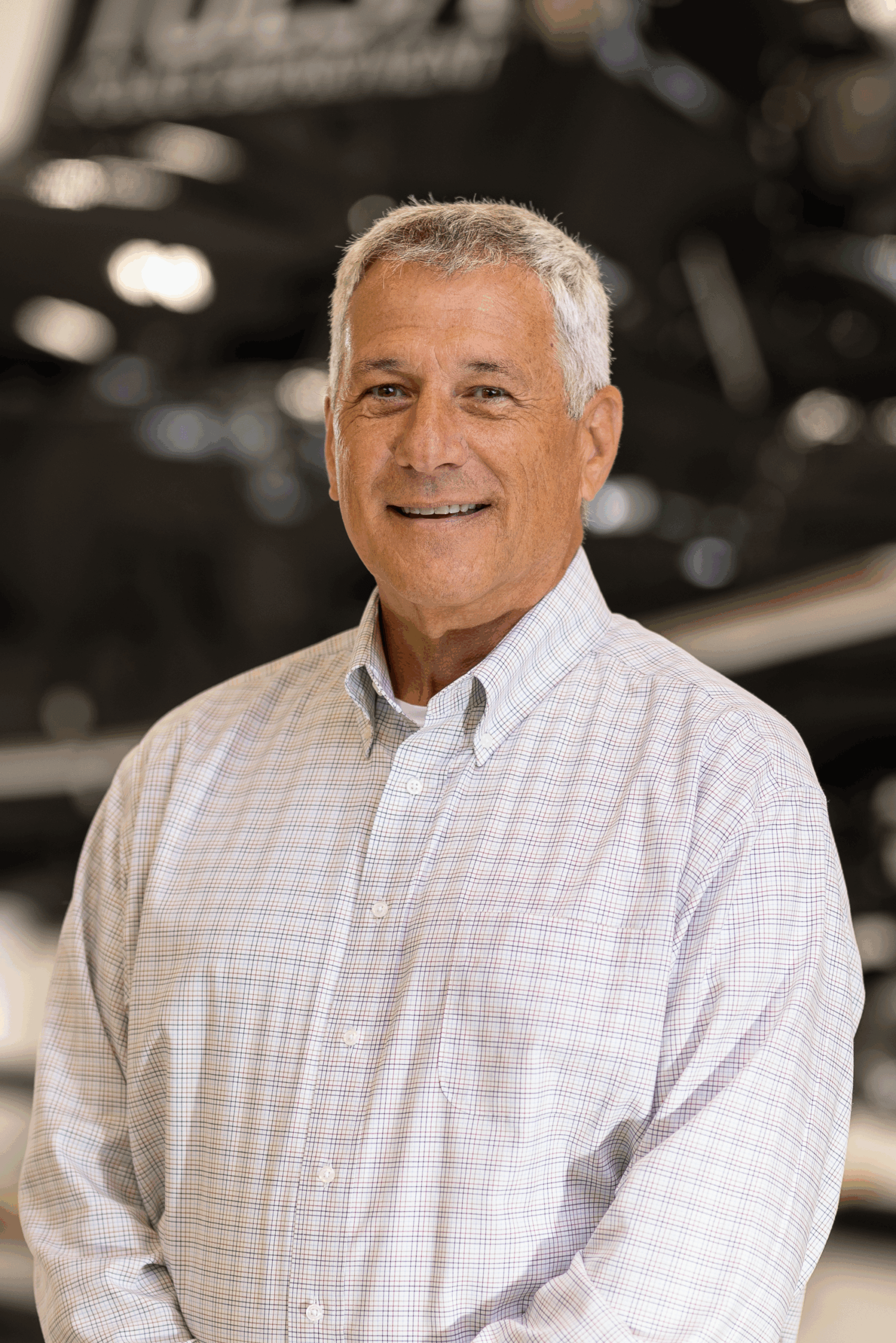 Smiling gray-haired man in button-up shirt